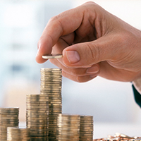 a hand stacks coins